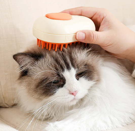 Person using the 3 In 1 Steam Pet Grooming Brush on a fluffy cat for grooming and relaxation.